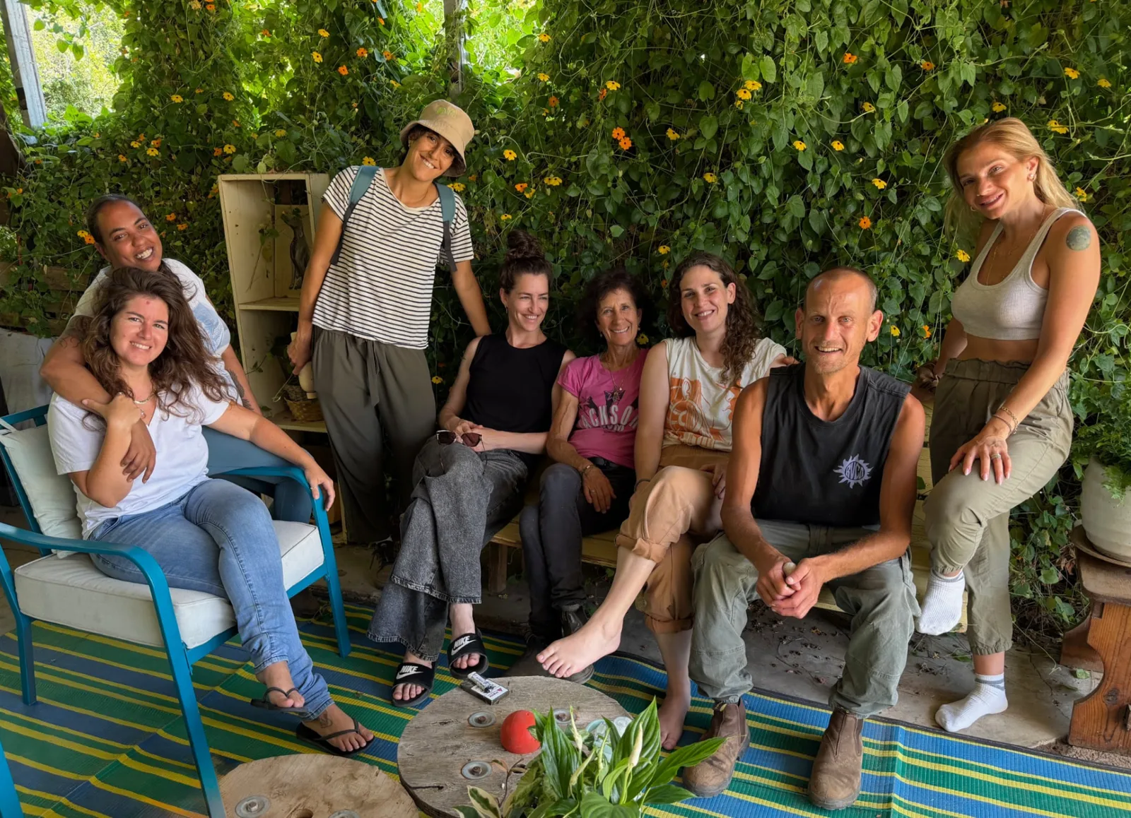 A group gathered beneath flowering greenery
